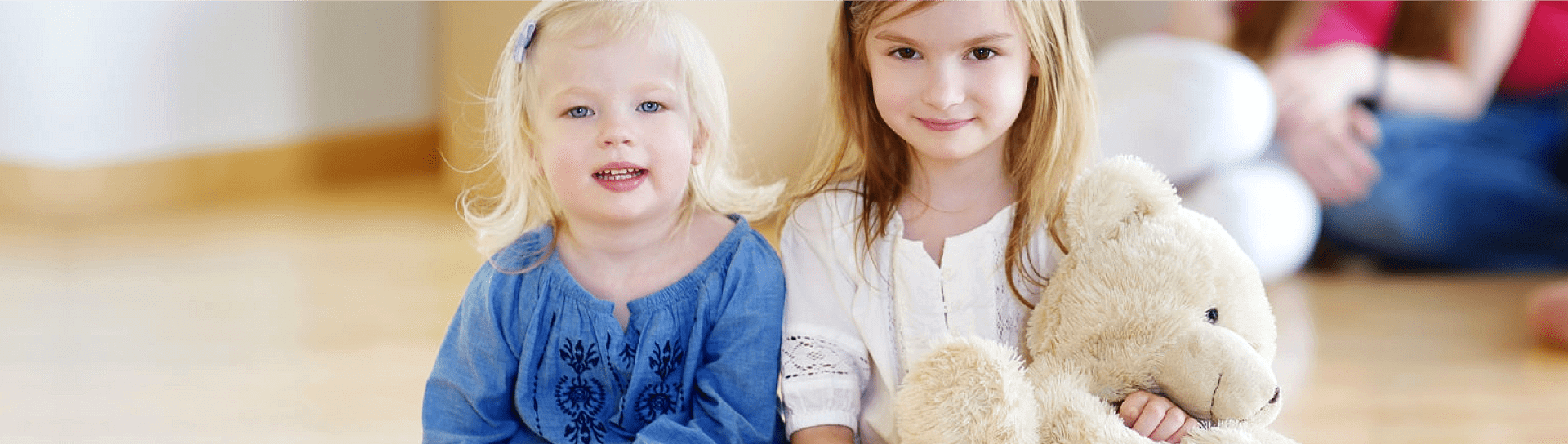little girls playing teddy bear