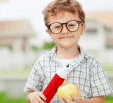 boy holding an apple and a big pencil