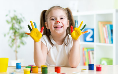 smiling kid with finger paint